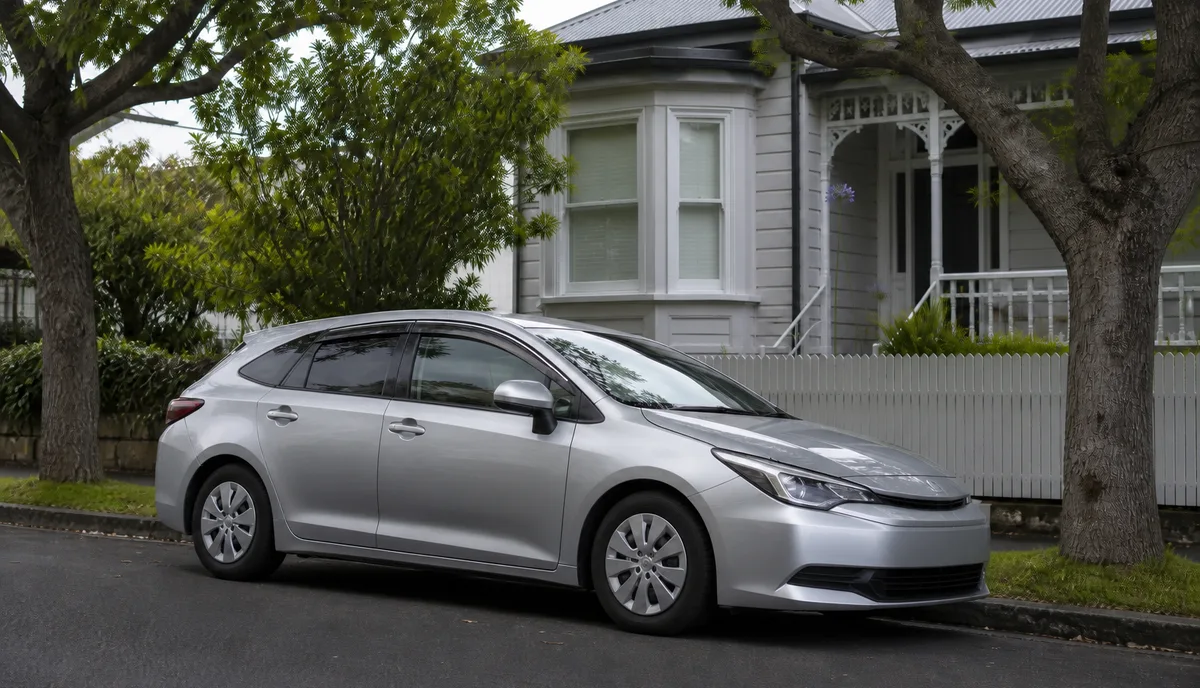 A hybrid station wagon parked on a residential street